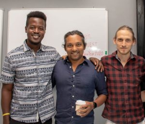 CamSKOOL team members Idris Kamara, Simon, and Vinimay standing together, representing the leadership behind the platform.